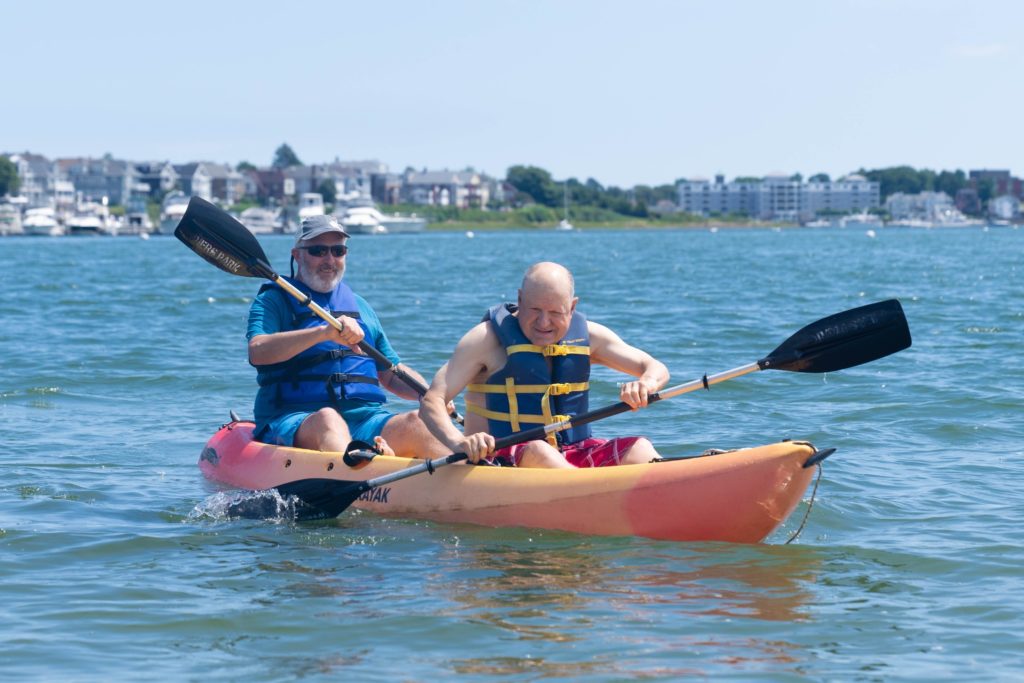 CEO Coleman Nee kayaks with a resident at our annual Beach:Ability event.