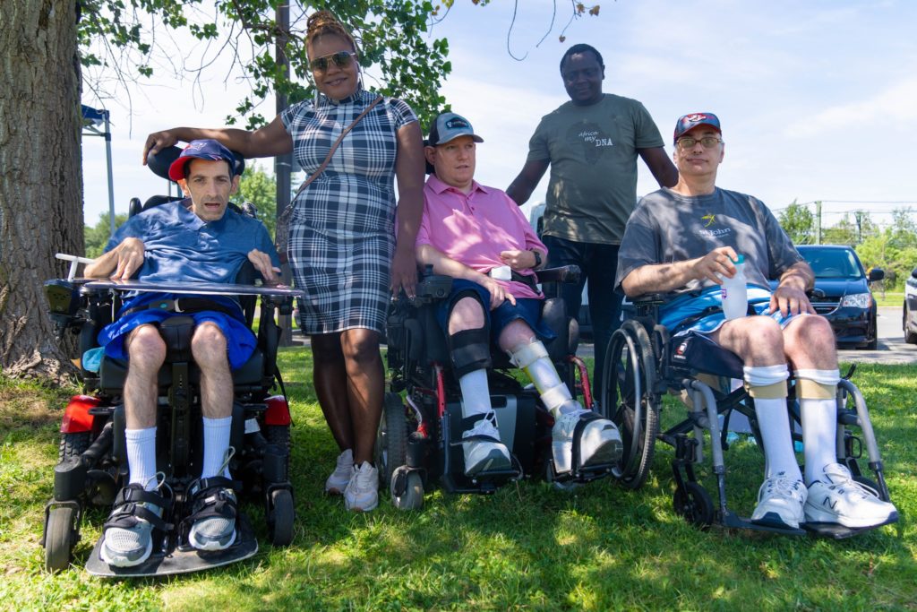 Triangle staff and residents enjoy a break in the shade at Beach:Ability.