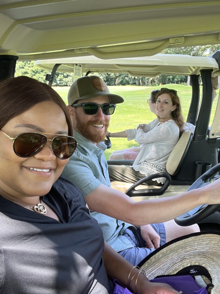 Triangle staff and participants ride in golf carts at our annual Golf Tournament.