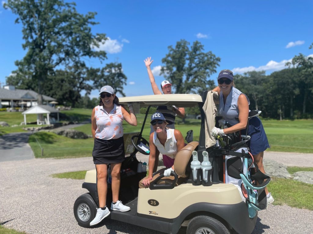 Four golfers enjoy the beautiful day at our annual Golf Tournament.